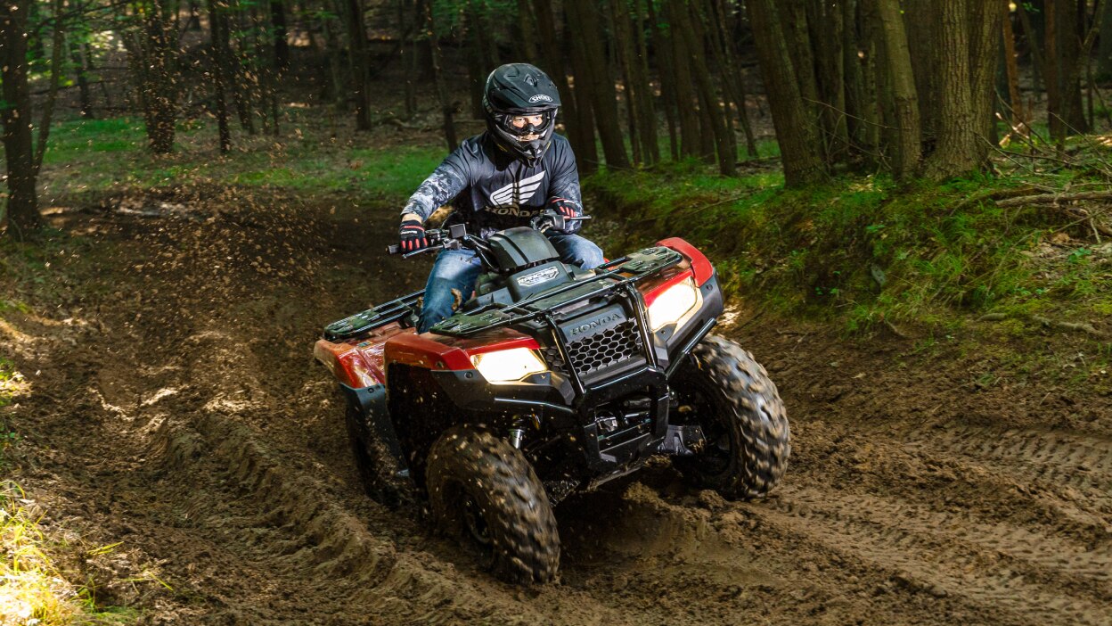 Front view of Driver on Rancher going through muddy.