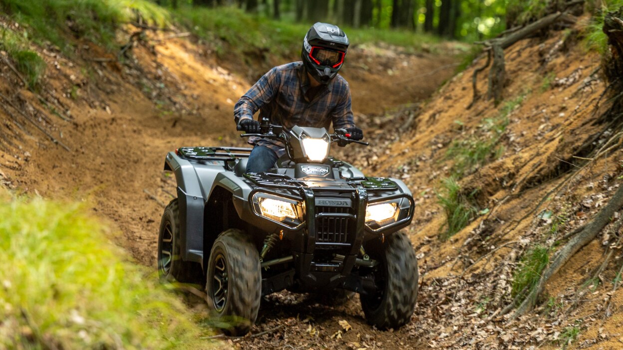 Front view of rider on Rubicon on dirt track.