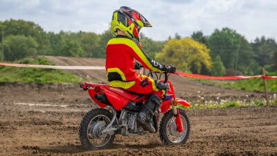 Rear view of you rider on dirt track.