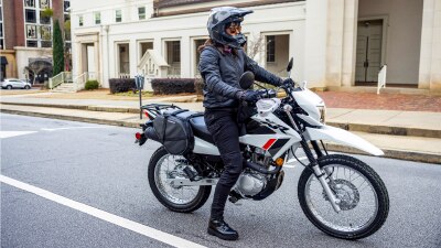 A rider on a XR150L topped at an intersection. 