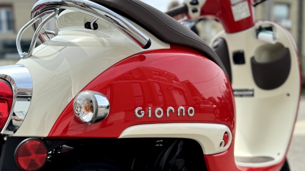 An up close Fighting Red Honda Giorno in the studio.