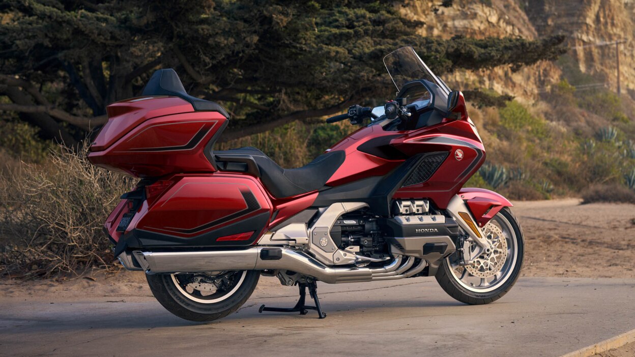 Right facing image of Gold Wing Tour Airbag, stationary on road. Green tree in background.