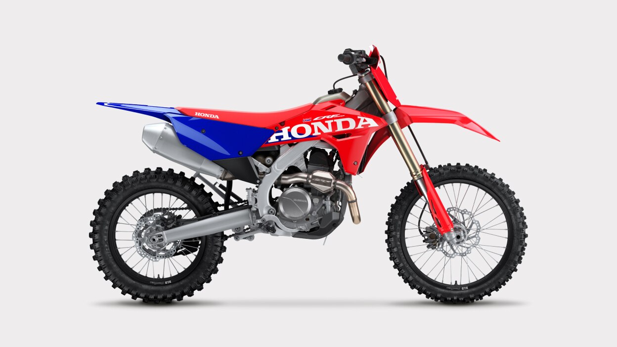 Side profile view of a red and blue dirt bike.