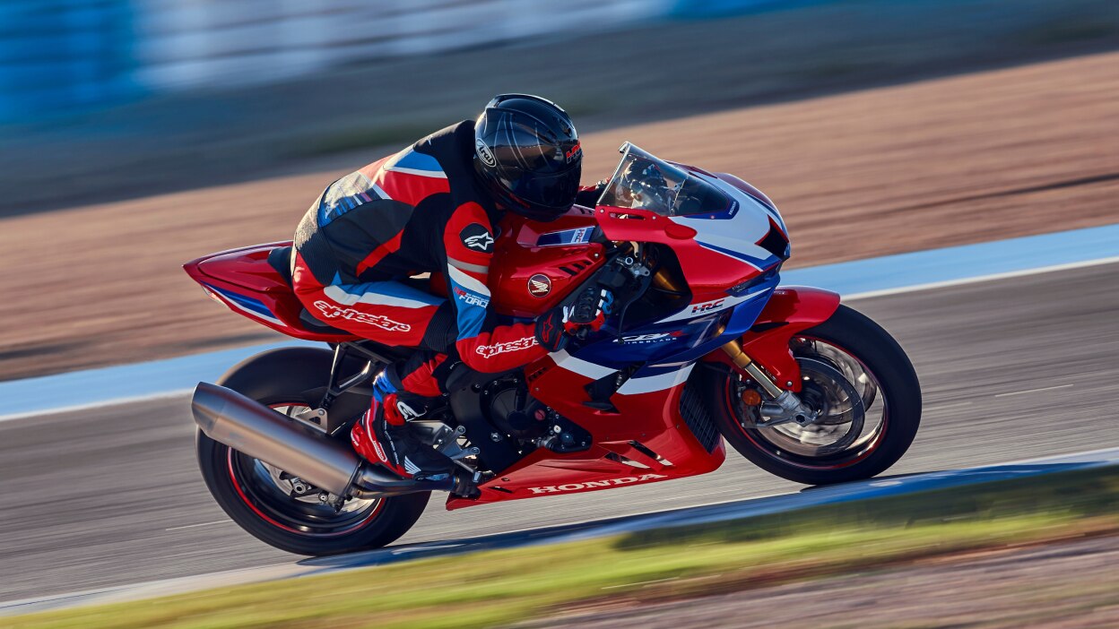 Rider on CBR1000RR-R Fireblade going right on race track.